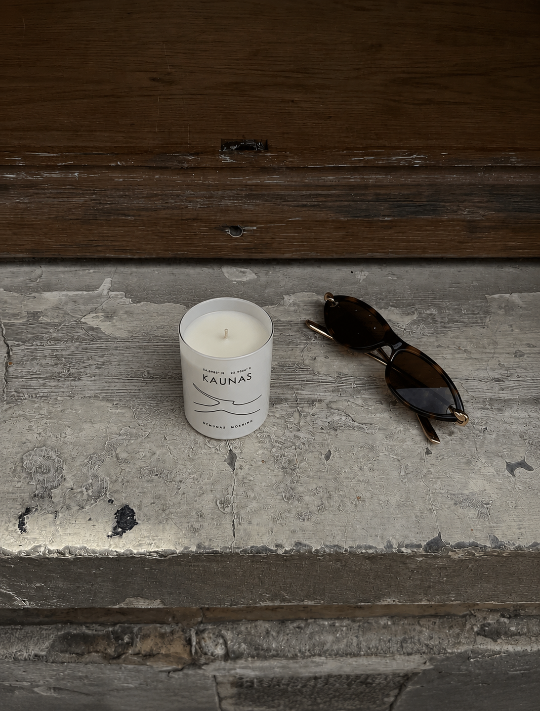 The Kaunas candle resting on a weathered wooden bench